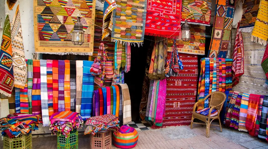 a store with colorful rugs and blankets in Agadir