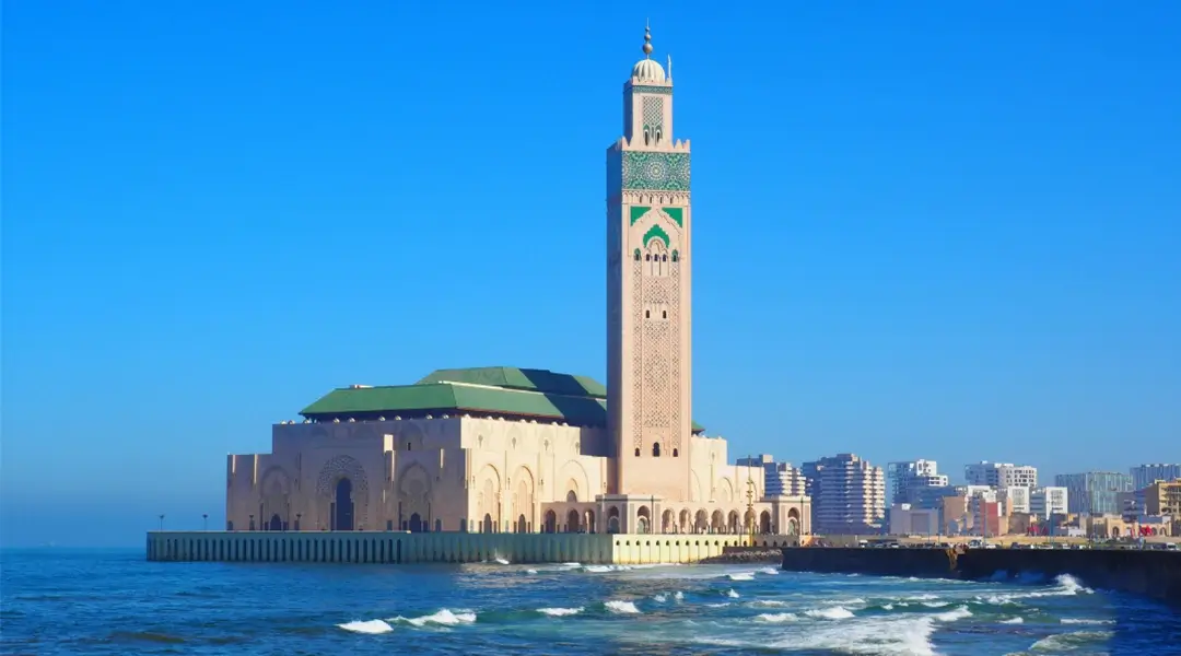 a building with a tall tower on the water