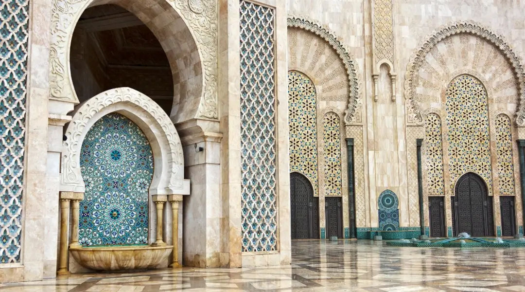 a large ornate building with arches and doors